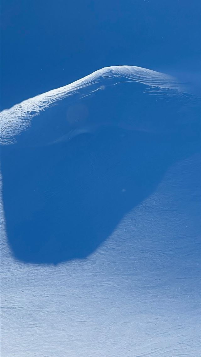 1290x2796 a person riding a snowboard down a snow covered sl... -  iPhone Wallpaper