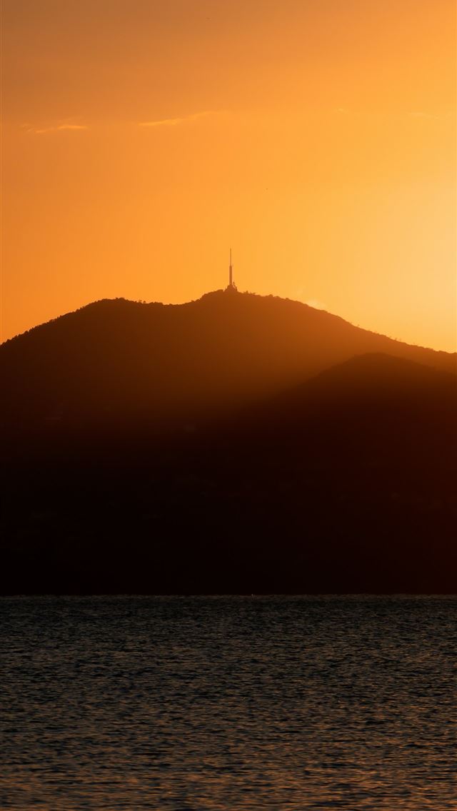 1290x2796 the sun is setting over a mountain with a body of ... -  iPhone Wallpaper