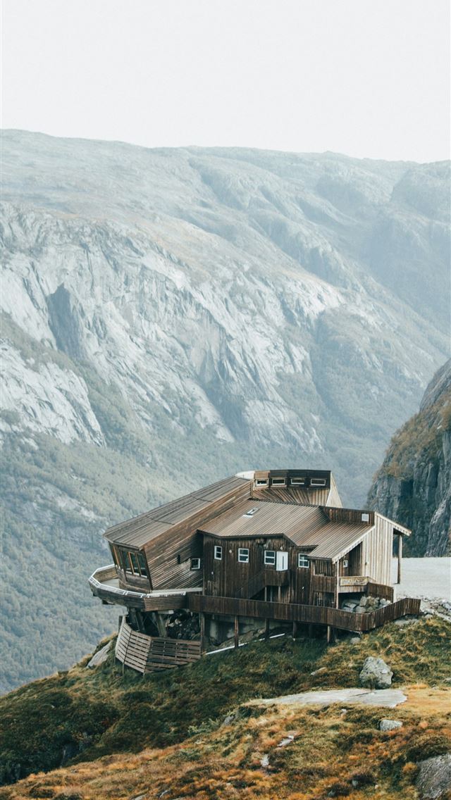 1290x2796 a house sitting on top of a lush green hillside -  iPhone Wallpaper