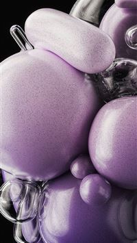 a glass vase filled with lots of purple balls wallpaper