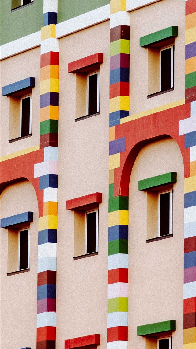 1290x2796 a multicolored building with a clock in front of i... - city iPhone Wallpaper