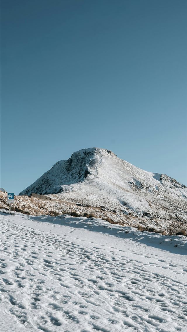 1290x2796 Snow covered mountain peak under a clear blue sky -  iPhone Wallpaper