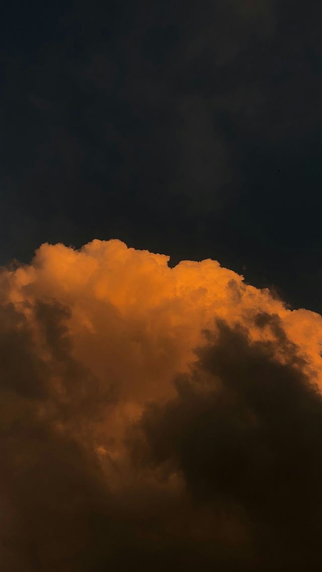 1290x2796 a plane flying through a cloudy sky at night -  iPhone Wallpaper