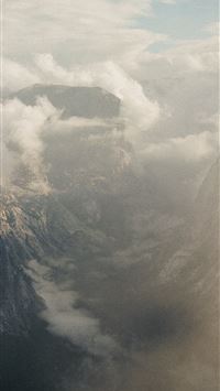 Misty mountain peaks shrouded in clouds wallpaper