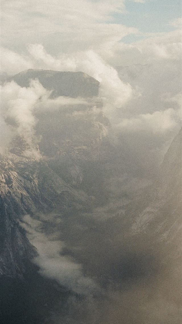 1290x2796 Misty mountain peaks shrouded in clouds -  iPhone Wallpaper