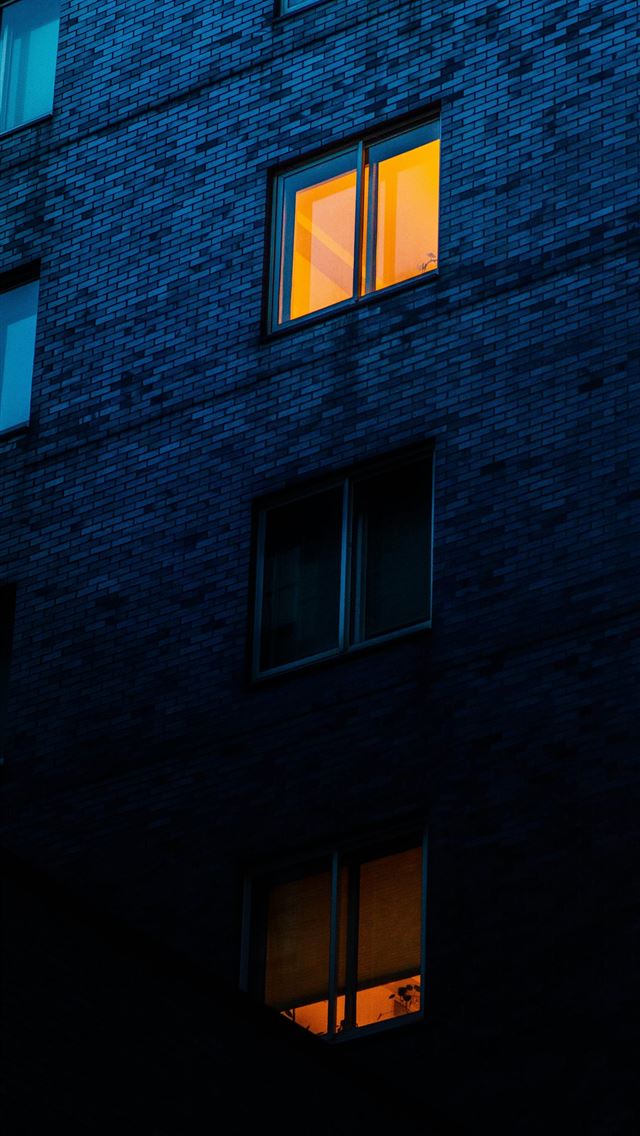 1290x2796 a tall building with windows lit up at night - city iPhone Wallpaper