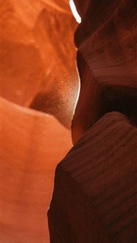 Sunlight streams through a narrow sandstone canyon... wallpaper