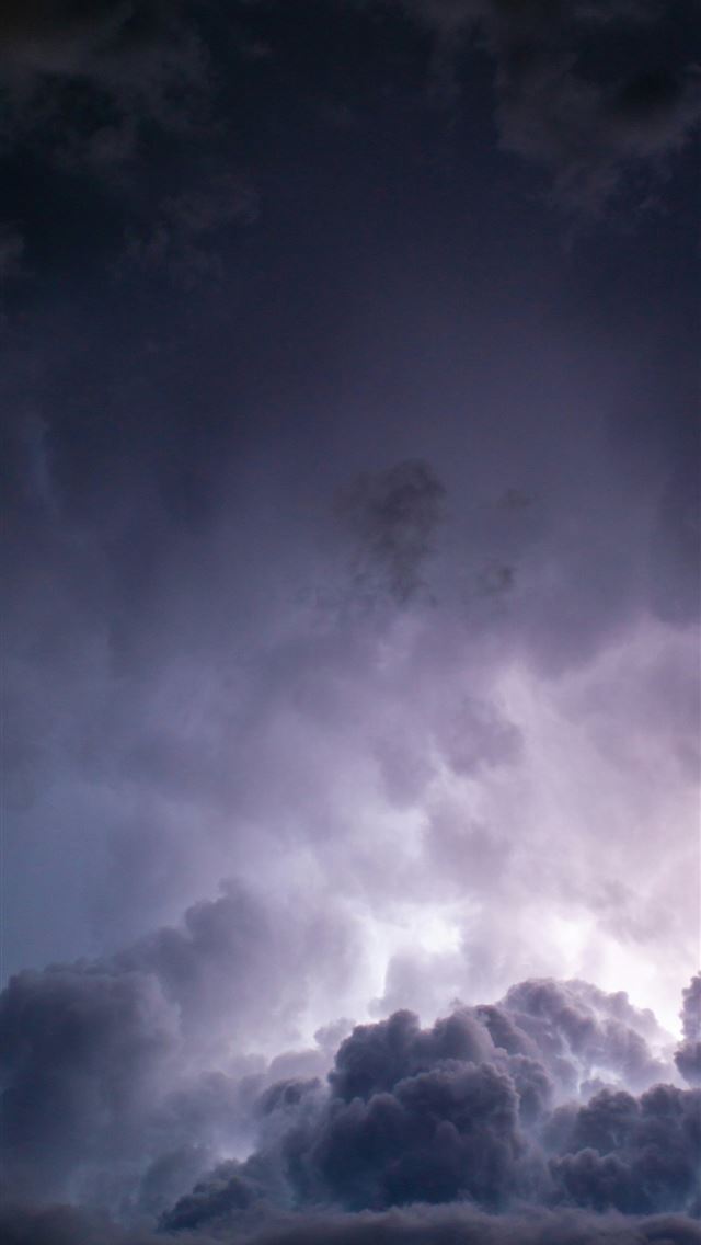 1290x2796 a plane flying through a dark cloudy sky - sony iPhone Wallpaper