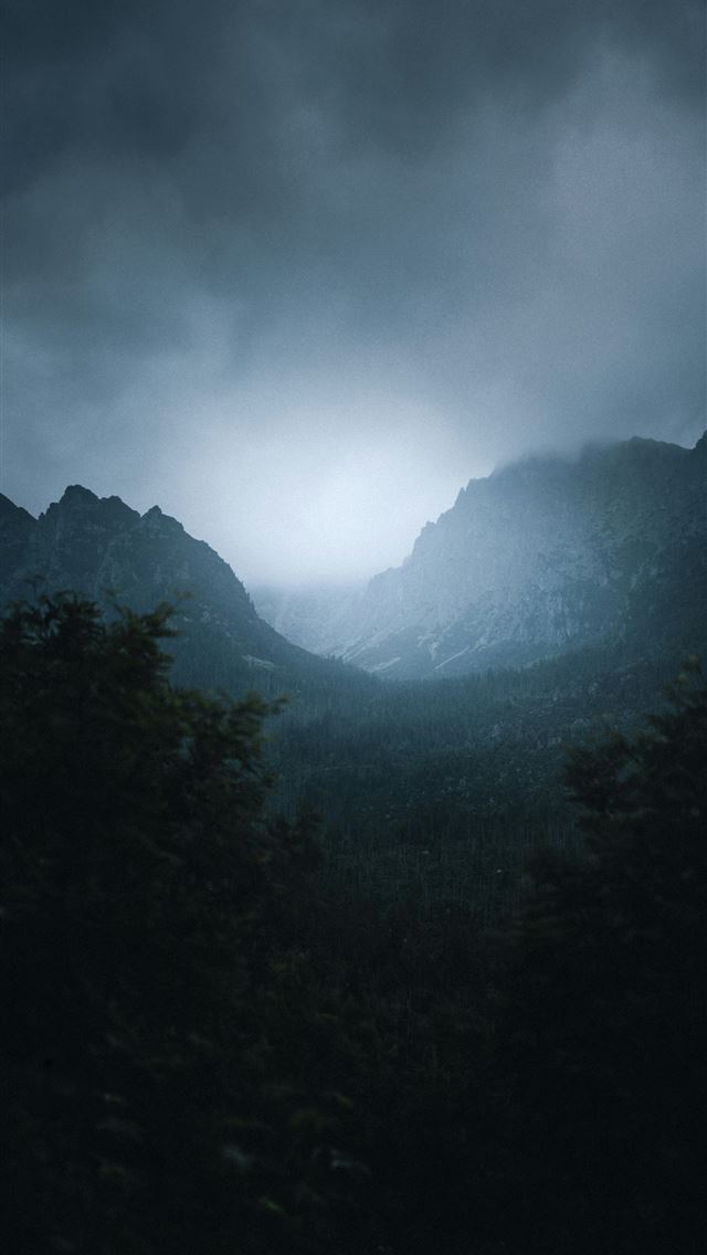 1290x2796 Misty mountains shrouded in dark clouds at dawn  - cloudy sky iPhone Wallpaper