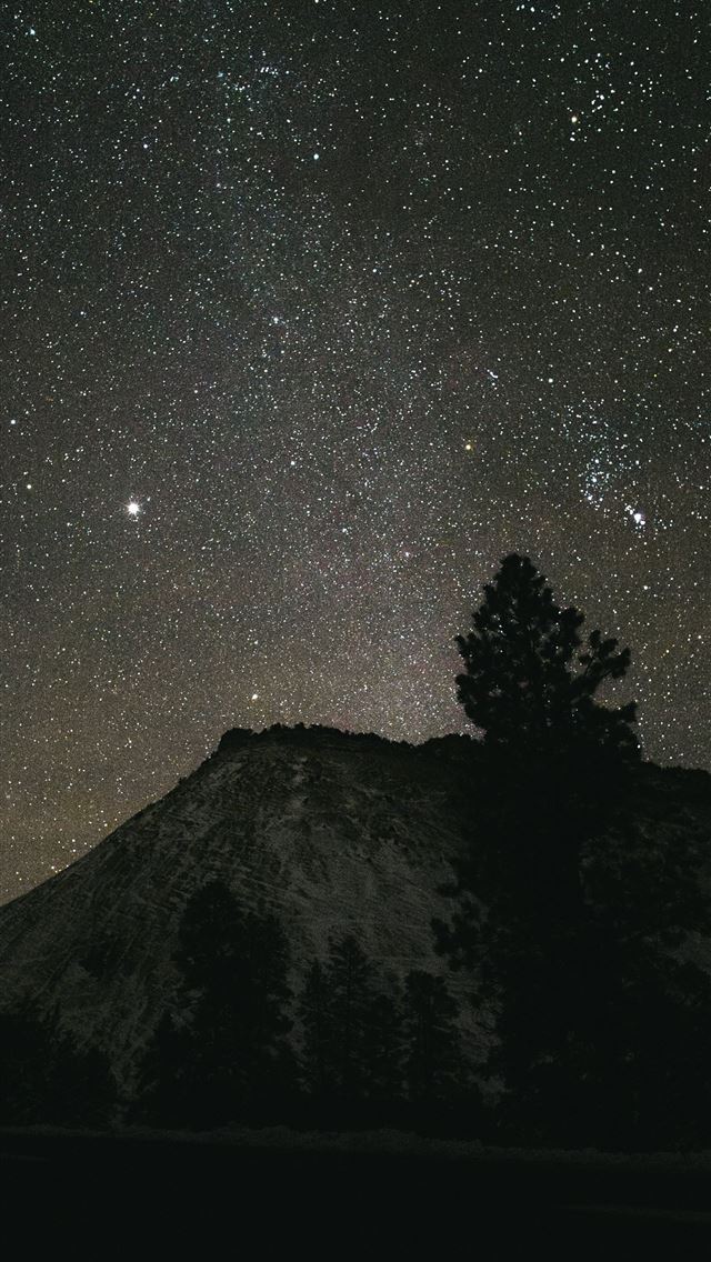 1290x2796 Starry night sky over a silhouetted mountain peak  -  iPhone Wallpaper