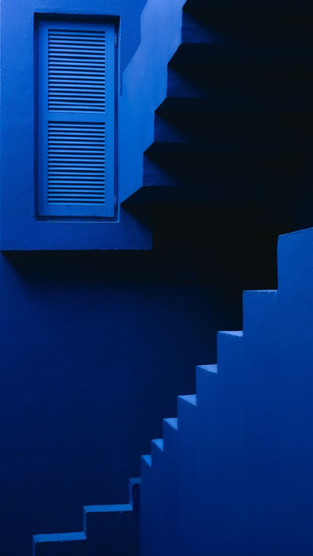 1290x2796 a blue staircase leading to a window in a building -  iPhone Wallpaper