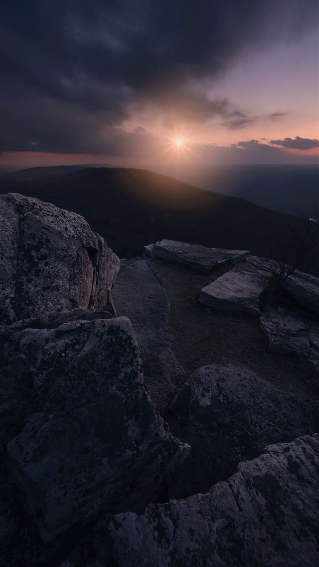 1290x2796 the sun is setting over a rocky outcropping - sunset iPhone Wallpaper