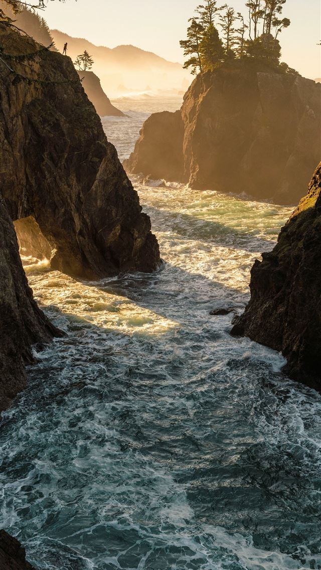 1290x2796 a body of water surrounded by rocks and trees -  iPhone Wallpaper