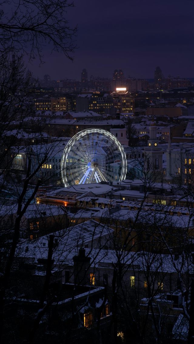 1290x2796 a ferris wheel in the middle of a city at night - urban iPhone Wallpaper