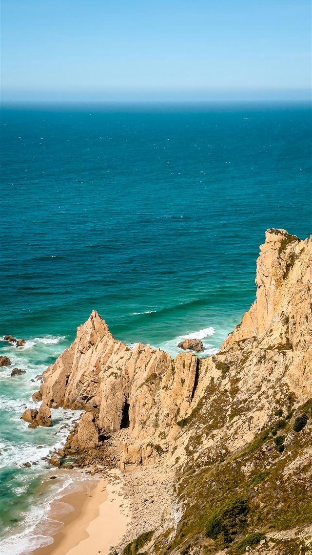 1290x2796 a view of the ocean from the top of a hill - waves iPhone Wallpaper