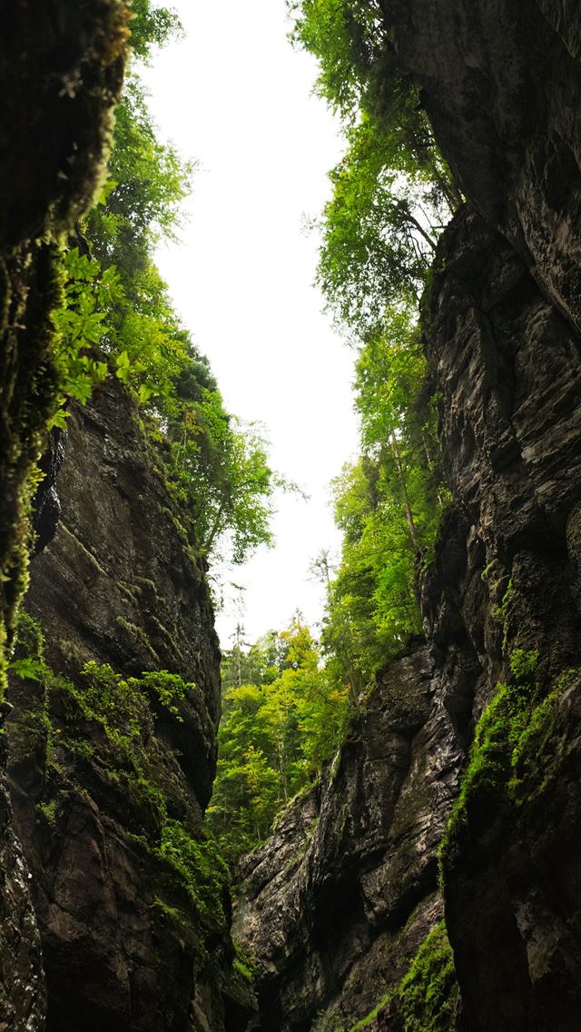 640x1136 a narrow river surrounded by rocks and trees -  iPhone Wallpaper