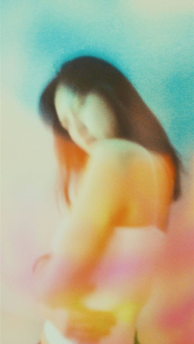 1290x2796 a blurry photo of a woman in a bikini - colorful iPhone Wallpaper