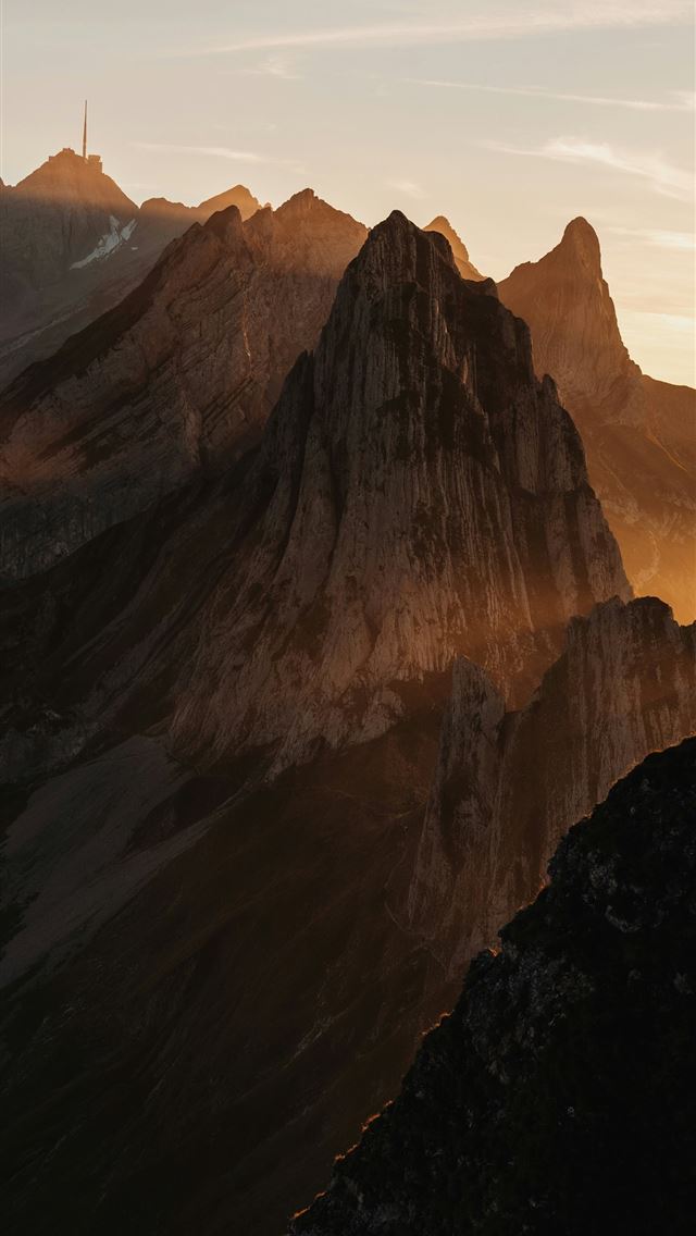 1290x2796 the sun is setting on a mountain range - sunset iPhone Wallpaper