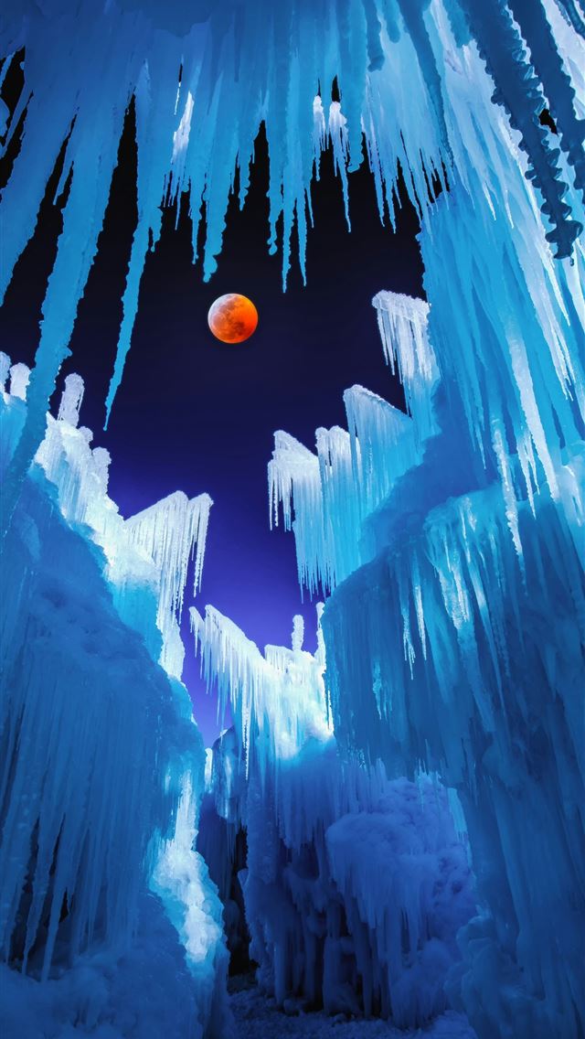 1290x2796 an orange ball is in the middle of ice formations - frozen iPhone Wallpaper