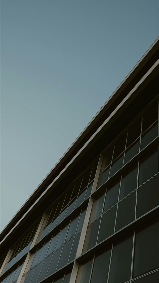 1290x2796 a tall building with lots of windows on top of it -  iPhone Wallpaper