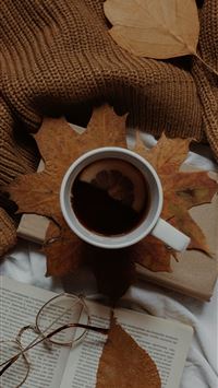 a cup of coffee and a book on a bed wallpaper