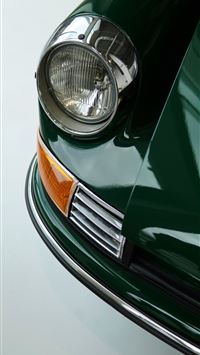 A classic green car's headlight shines  wallpaper