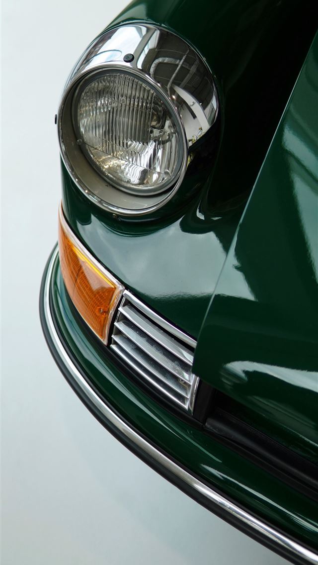 1290x2796 A classic green car's headlight shines  -  iphone 13 Wallpaper