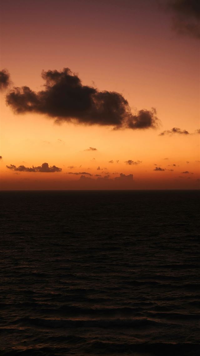 1290x2796 Dramatic sunset over a dark rippling ocean  -  iPhone Wallpaper