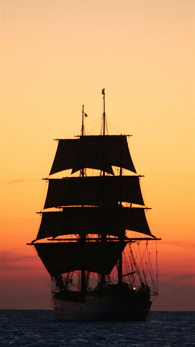 1290x2796 A tall ship sails on the ocean at sunset  -  iPhone Wallpaper