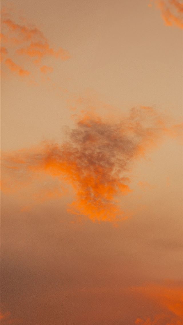 1290x2796 Orange clouds drift in a soft hazy sky  -  iPhone Wallpaper