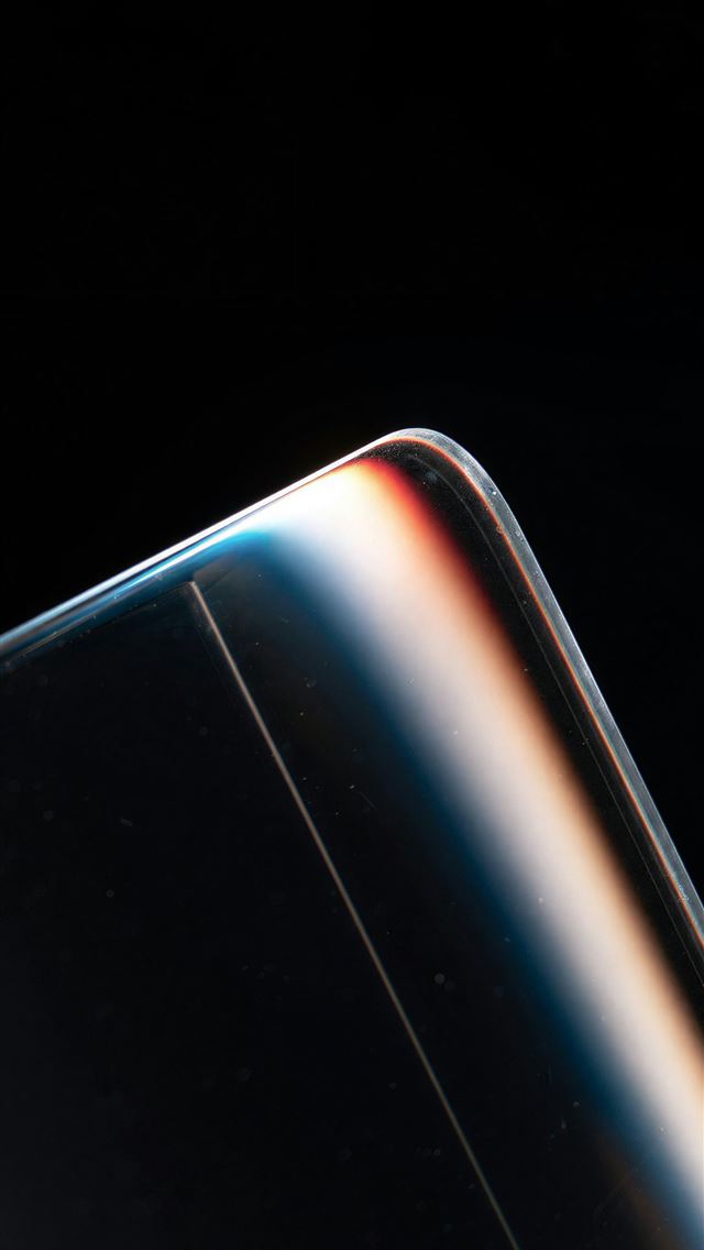 1290x2796 Close up of a curved glass edge with colorful ligh... -  iPhone Wallpaper