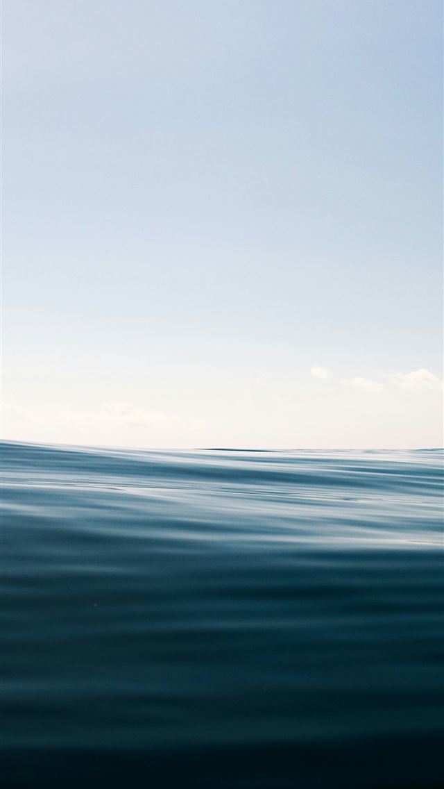 1290x2796 Calm ocean waves under a clear sky -  iPhone Wallpaper