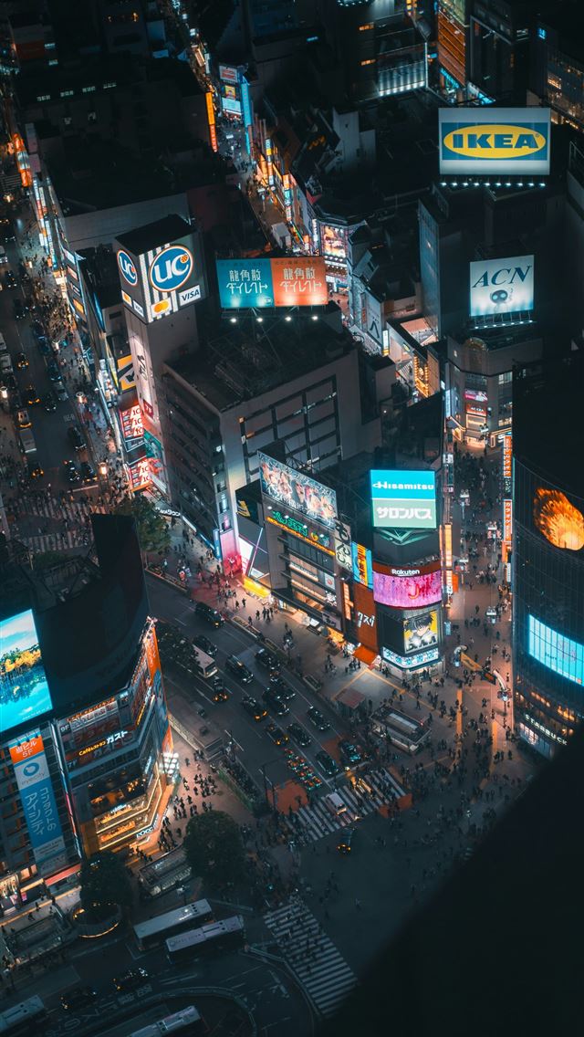 1290x2796 Aerial view of a bustling city street at night  - buildings iPhone Wallpaper