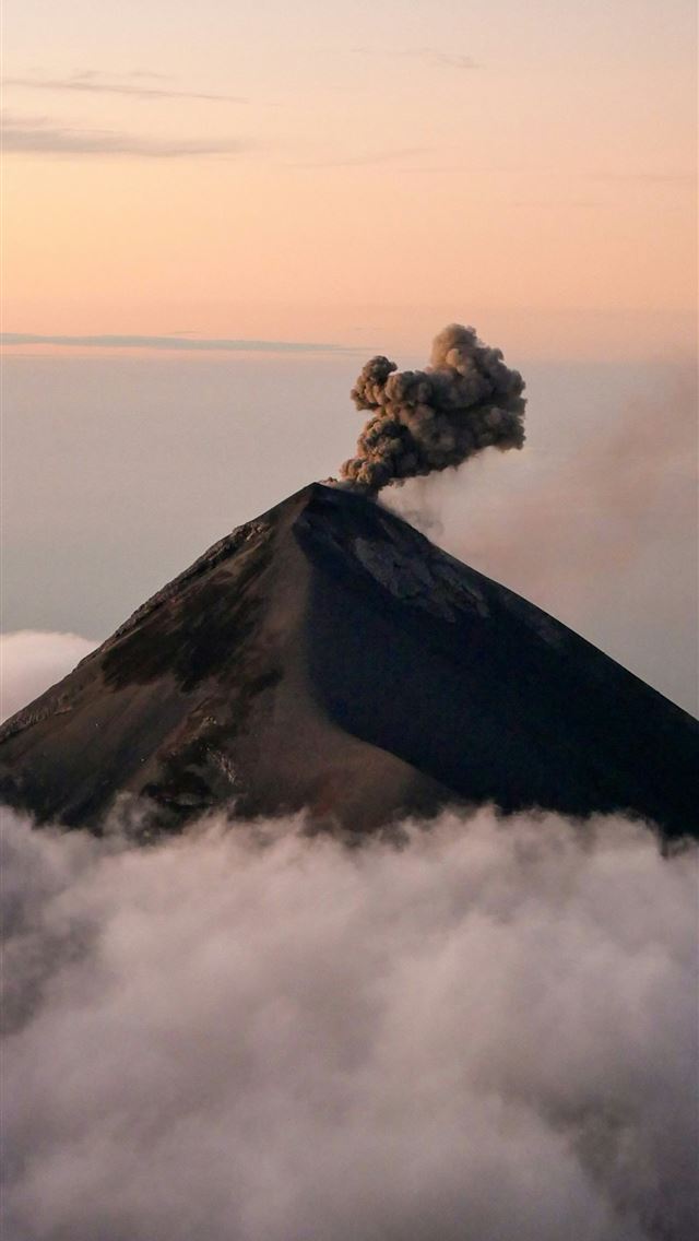1290x2796 Volcano erupting smoke above clouds at sunset -  iPhone Wallpaper
