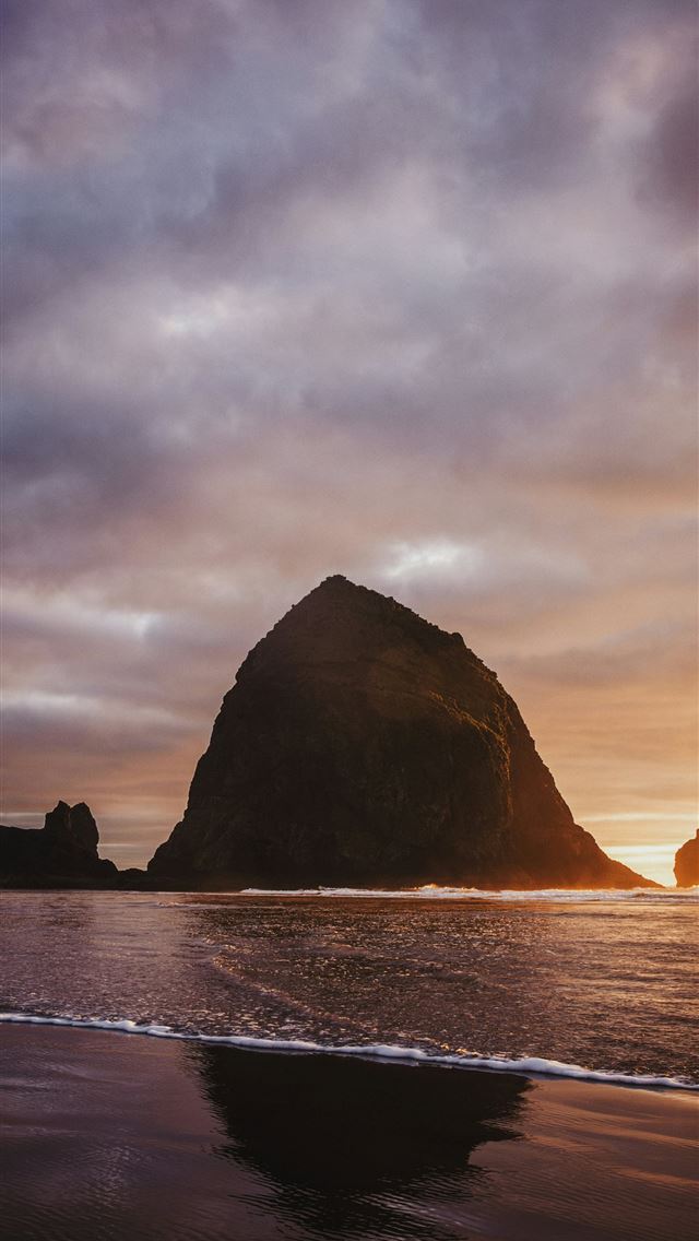 1290x2796 Dramatic rock formations on a beach at sunset -  iPhone Wallpaper