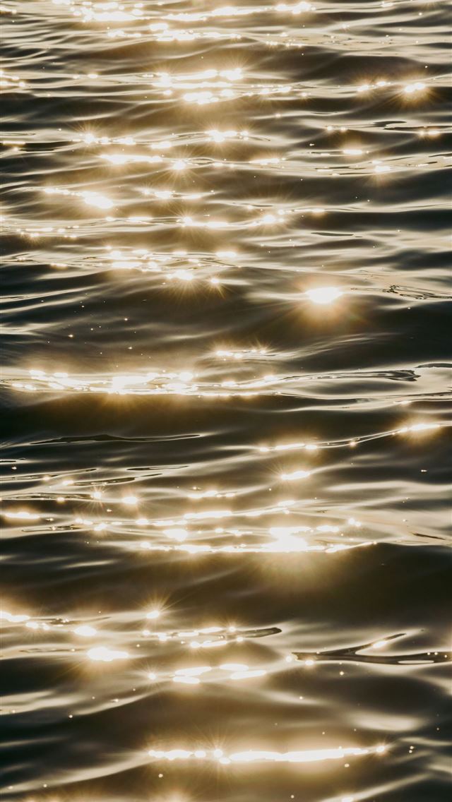 640x1136 Sunlight sparkles on dark rippling water  -  iPhone Wallpaper