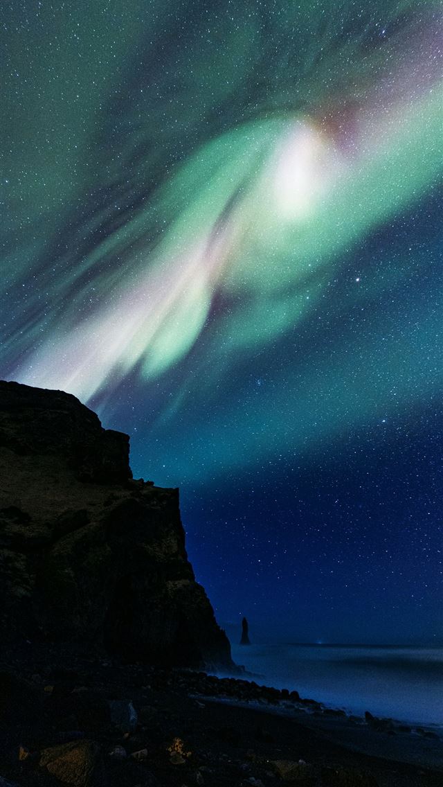 1290x2796 Aurora borealis illuminates dark night sky over oc... -  iPhone Wallpaper