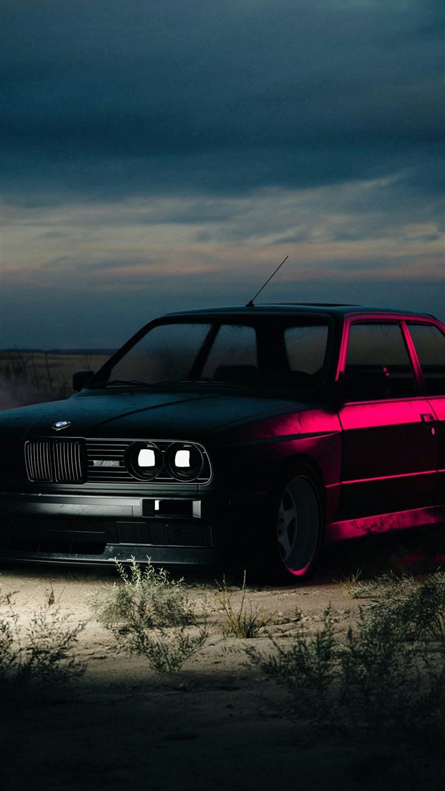 1242x2688 A car parked on a dirt road under a cloudy sky -  iPhone Wallpaper
