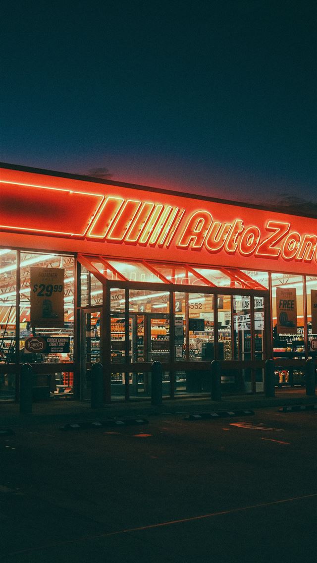 1290x2796 Autozone store entrance illuminated at night -  iPhone Wallpaper