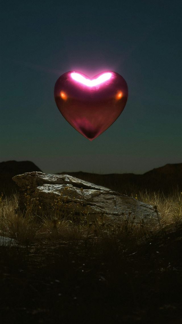1242x2688 a heart shaped object floating in the air -  iPhone Wallpaper
