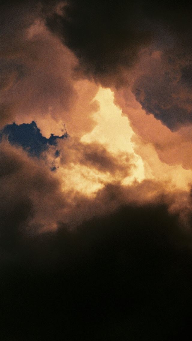 1290x2796 Golden light illuminates dark dramatic storm cloud... -  iPhone Wallpaper