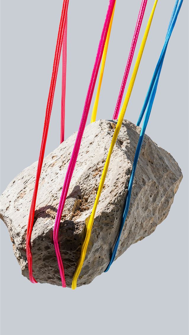 1290x2796 A rock is suspended by colorful strings - red iPhone Wallpaper