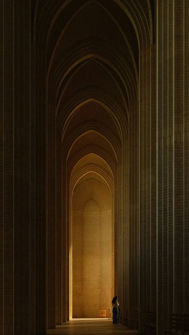 1290x2796 A person in a long corridor with tall arched brick... -  iphone 13 Wallpaper
