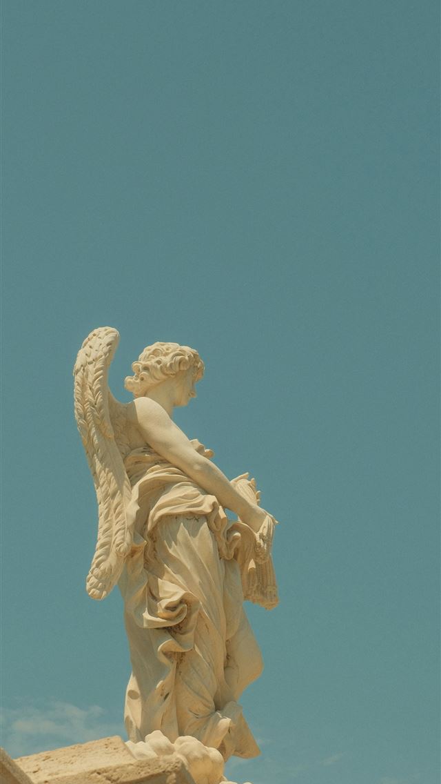 1290x2796 A stone angel statue with feathered wings against ... -  iphone 13 Wallpaper