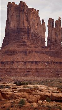 brown rock formations under white sky at daytime wallpaper