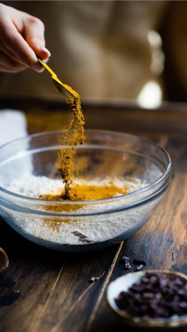 640x1136 Sprinkling Turmeric - hand iPhone Wallpaper