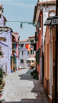 Laundry drying in alley  colourful Burano wallpaper