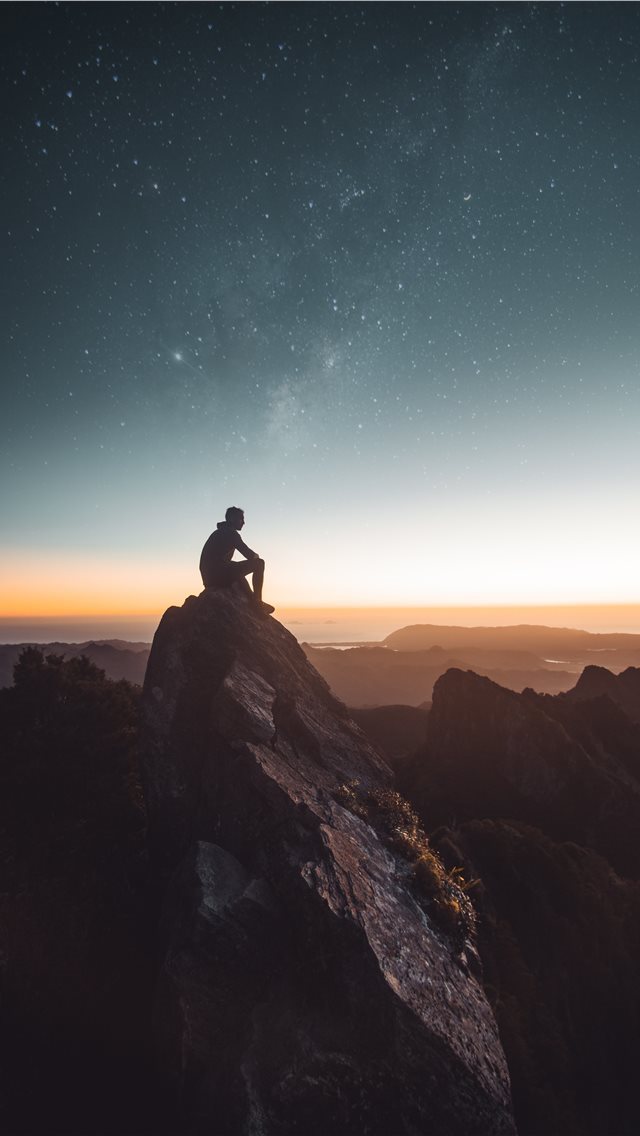 640x1136 silhouette of person sitting on rock formation dur... -  iPhone Wallpaper