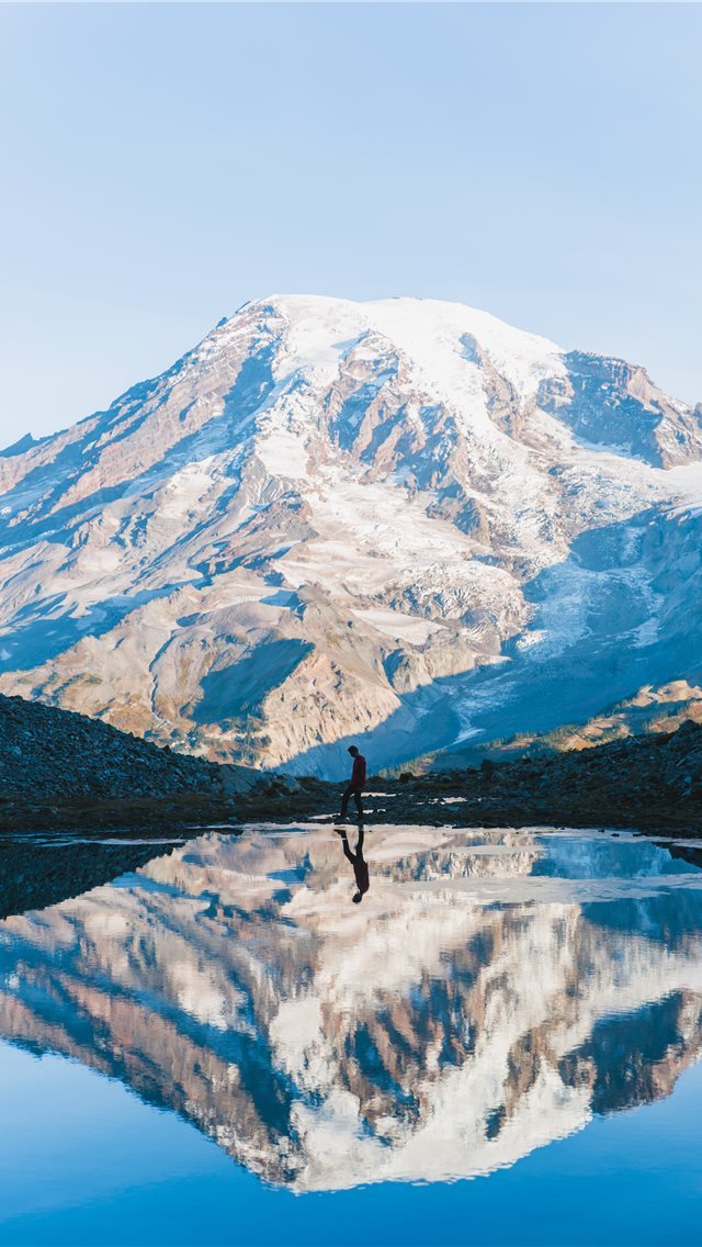 640x1136 man walking near glacier mountain during day -  iPhone Wallpaper