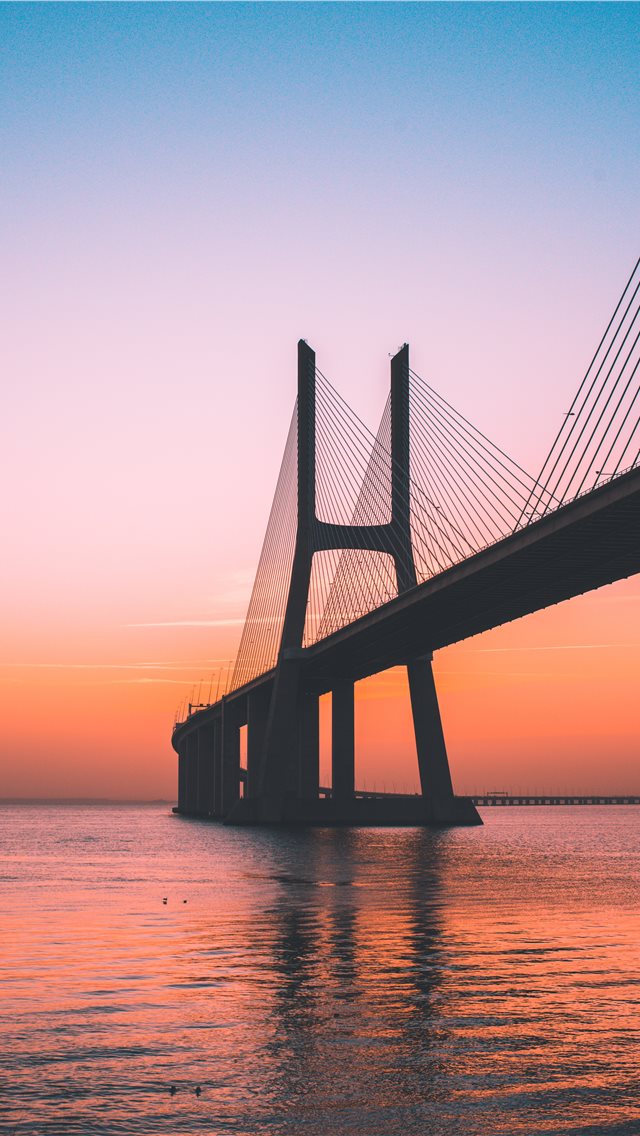 silhouette of bridge under clear sky iPhone wallpaper 